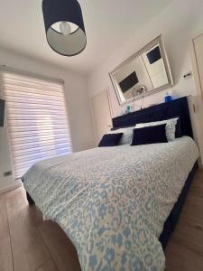 a bedroom with a bed with a blue and white comforter at La Reggia b&b in Bergamo