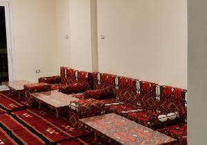a room with a couch and tables on a rug at Pyramids Gardens 2bedroom apartment in ‘Ezbet `Abd el-Ḥamîd
