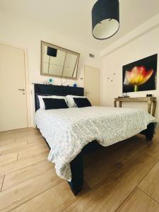 a bedroom with a large bed with a black headboard at La Reggia b&b in Bergamo