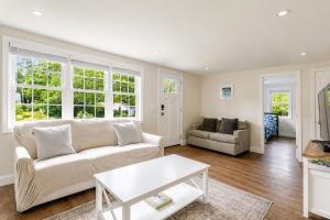 a living room with a couch and a table at Dennis Beach House - Walk to Beach - Pet Friendly in Dennis