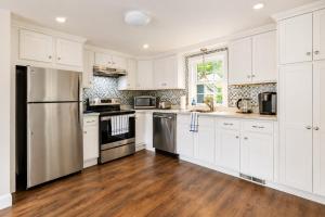a kitchen with white cabinets and stainless steel appliances at Dennis Beach House - Walk to Beach - Pet Friendly in Dennis