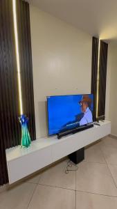 a flat screen tv sitting on top of a table at Gods Grace homes in Duasi +1 photo