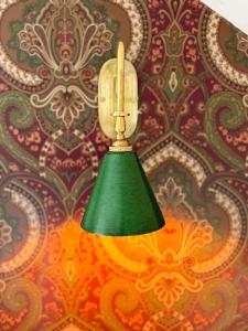 a green lamp hanging from a wall at The White Rabbit Rooms in Broadford +72 photos