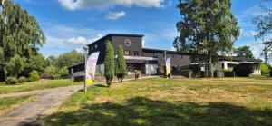 a black building with signs in front of it at Frostavallen Hostel in Långstorp +10 photos