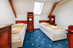 a small room with two beds and a window at Vila Sentandreja in Subotica +4 photos