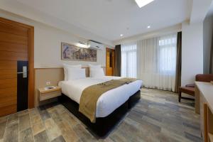 A bed or beds in a room at Nishant Hotel