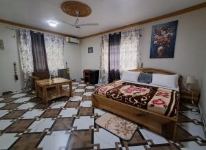 a bedroom with a bed and a table in it at Immanuel Victory Hotel & Restaurant in Ajenkotoku +93 photos