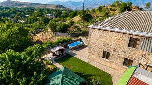 an aerial view of a stone house with a swimming pool at Adams Rest House in Yeghegnadzor
