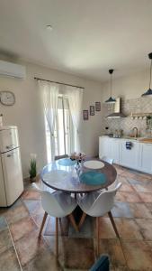 a kitchen with a table and chairs in a room at DIMORA REALE - Charming House Caserta in Casagiove