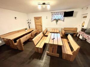 a room with wooden tables and a flat screen tv at 4-person room, sauna, Masuria in Ruciane-Nida +16 photos
