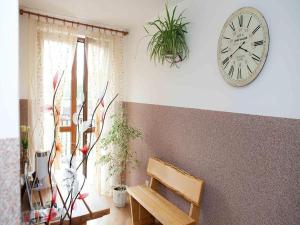 a clock hanging on a wall next to a bench at 4-person room, sauna, Masuria in Ruciane-Nida