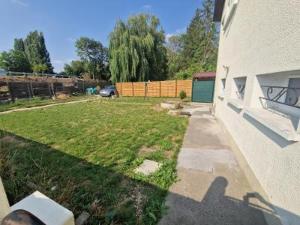 a shadow of a person on the side of a house at Ground-Floor Apartment With private Garden in Étampes