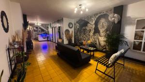 a living room with a large painting on the wall at Mi Casa18 in Santa Marta