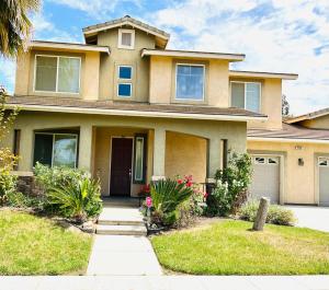 a large house with a driveway in front of it at la paz room 1 in Fresno
