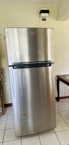 a stainless steel refrigerator sitting in a kitchen at Guest house 2 in Upper Conaree