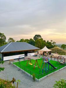 a park with a playground with a slide at Mount Ocio Pool Resort Wayanad, Chulliyode in Ambalavayal