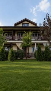 a large house with a lawn in front of it at Shtil in Kyiv