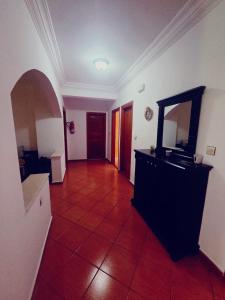 a hallway with a mirror and a dresser in a room at Sary's Hotel in M'diq