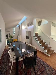 a dining room with a table and chairs and a staircase at B&B Remì in Gemmano +34 photos