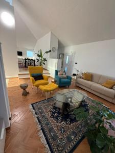 a living room with a couch and chairs and a table at B&B Remì in Gemmano