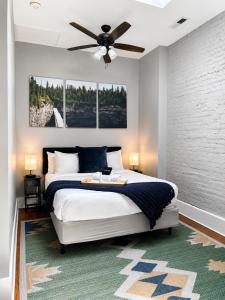 a bedroom with a bed with a ceiling fan at Historic Main St Apt | Private Garage in St. Charles