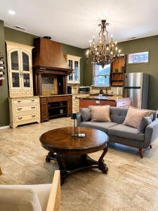 a living room with a couch and a table at Historic Main St Apt | Private Garage in St. Charles