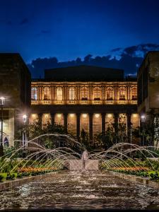 a fountain in front of a building at night at Six Hotel Guadalajara Degollado in Guadalajara