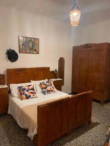 a bedroom with a large wooden bed with pillows at Baia Serena in Sestri Levante