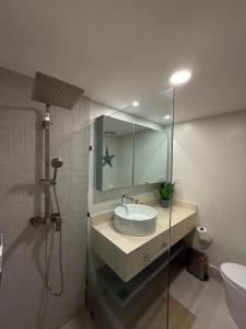 a bathroom with a sink and a shower with a mirror at Xanadu Casa De La Playa in Puerto Plata +30 photos