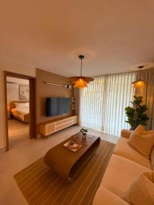 a living room with a couch and a tv at Xanadu Casa De La Playa in Puerto Plata