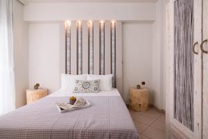 a bedroom with a white bed with a towel on it at Villa Ioanna in Potos