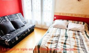 a bed and a couch in a room at Hostellerie de la juhel in Villaines-la-Juhel +7 photos