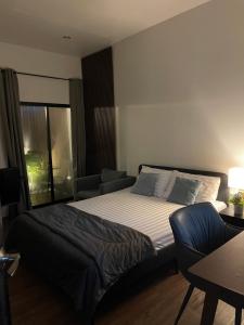 a bedroom with a bed and a couch at Hidden courtyard in Ban Bang Phun +10 photos