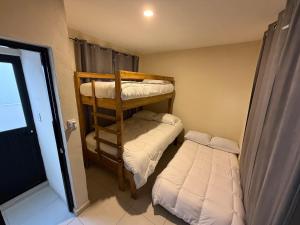 a small room with two bunk beds and a window at Casa Cielo del Mar in Ciudad Madero