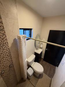 a small bathroom with a toilet and a shower at Casa Cielo del Mar in Ciudad Madero +14 photos