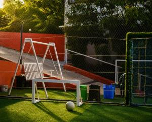 a batting cage with a chair and a goal at T Hill Vythiri Pool Resort in Vythiri
