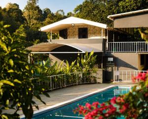 a house with a swimming pool in front of a building at T Hill Vythiri Pool Resort in Vythiri +32 photos
