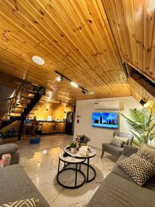 a living room with a couch and a table at أكواخ المها oryx cottage in Ajloun