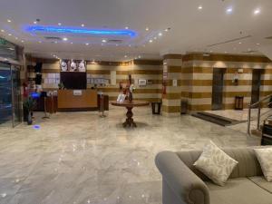 a lobby with a couch and a table in a building at فندق تاج النخبة - Taj Nakhba Hotel in Jazan