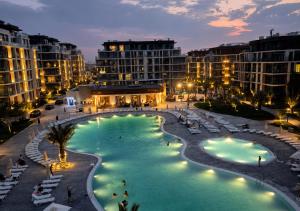 a view of a resort pool at night at Cozy family apartment at Seabreeze Nardaran, Beach & Pool, Polo Residence in Baku