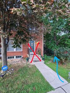 a x sign on the grass in front of a house at MALE Only Shared Basement in Frederick