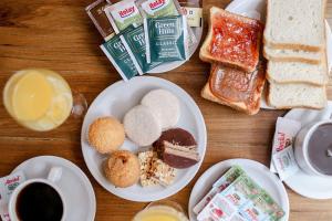 a table with plates of food and cups of coffee at Mar del Este in San Bernardo +49 photos