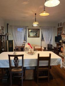 a dining room with a white table and chairs at Casale Santilli in Agnone