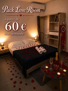a room with a bed and a table with hearts on it at Studio à la campagne in Le Moule