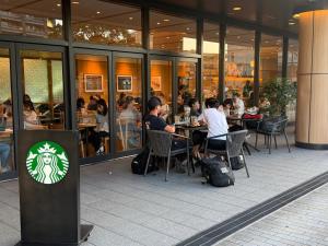 a group of people sitting at tables in a restaurant at WUMETEI Japanese-style lodge in Kyoto +20 photos