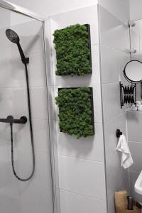 a bathroom with green plants on the wall at Gudere house in Enfield Lock