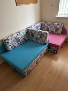 a couch with two cushions on it in a room at Gudere house in Enfield Lock