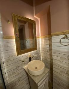 a bathroom with a white sink and a mirror at La Vida Dahab in Dahab