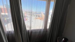 a large window with a view of a city at La Vida Dahab in Dahab