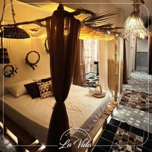a bedroom with a bed with a canopy at La Vida Dahab in Dahab +2 photos